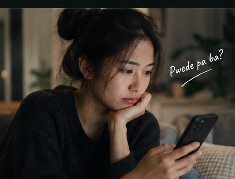A woman checking her phone and thinking about whether she can still spend